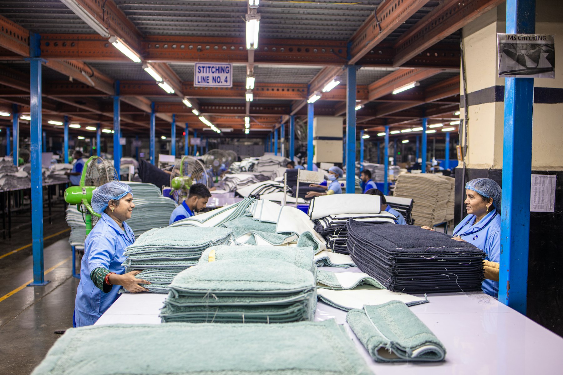 Workers on a production line inside a mill